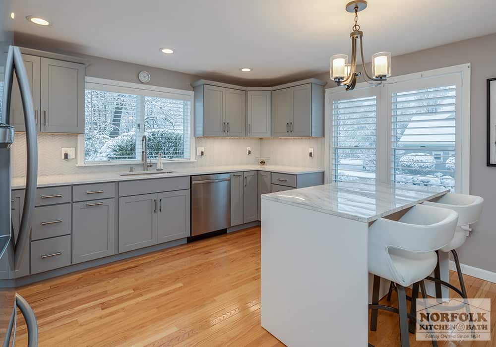 Grey kitchen cabinets in a u-shaped kitchen remodel with an island