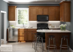 medium tone wood smaller kitchen with peninsula and stools 