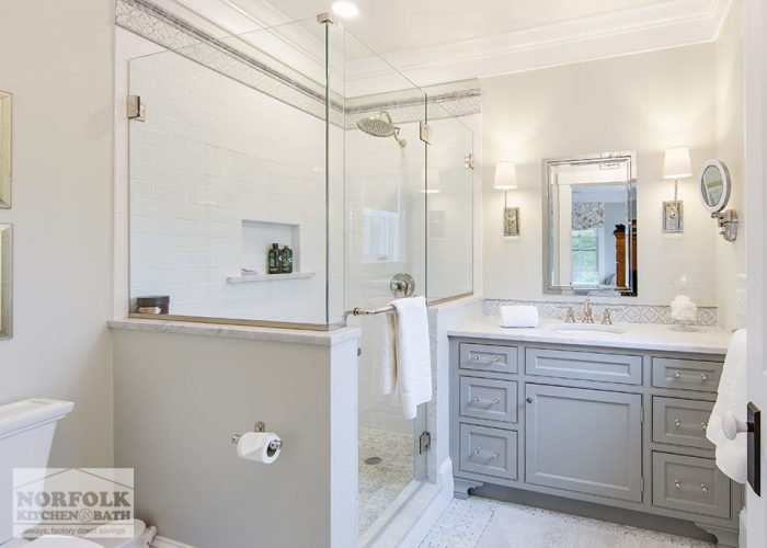 shower area with custom tile and grey vanity