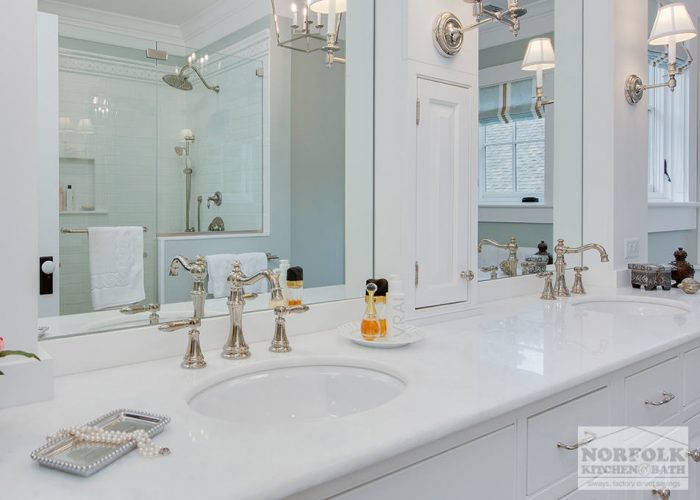 white bath countertop with brass faucet 