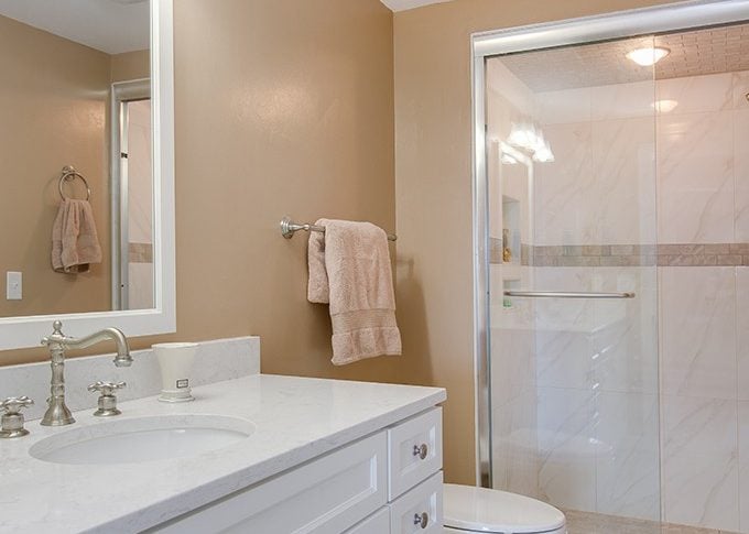whole bath shot showing vanity and toilet and shower door