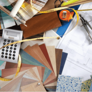 pile of designer samples and calculator and tape measure