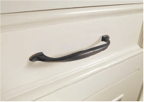 black decorative pull on white cabinet drawer